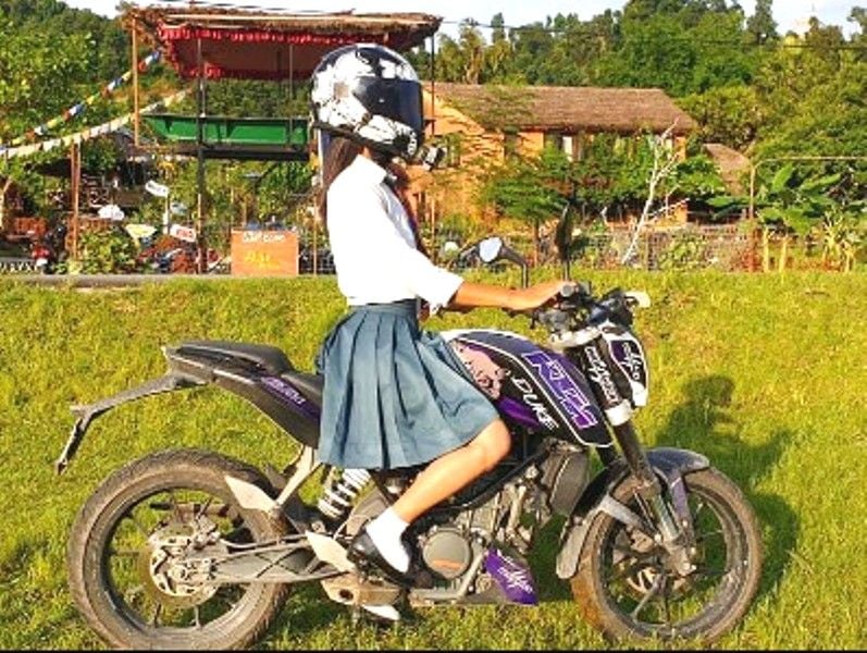 Savya KC riding her KTM Duke 200 while going to college