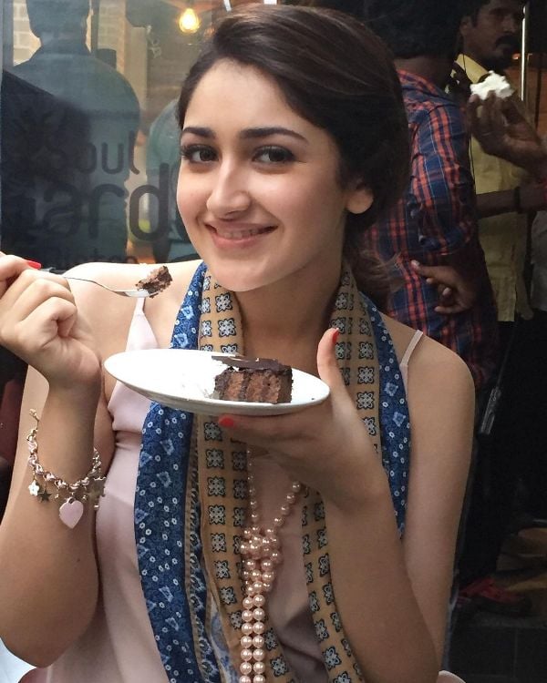 Sayyeshaa Saigal while having a slice of cake