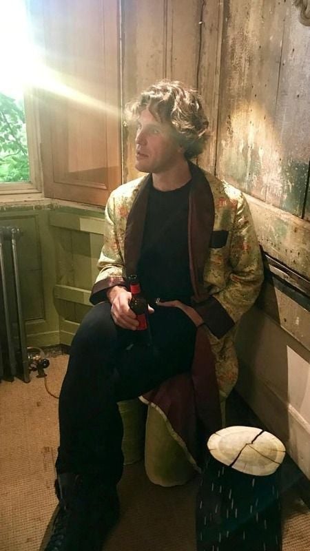 Sebastien Laurent Michel while holding a bottle of beer