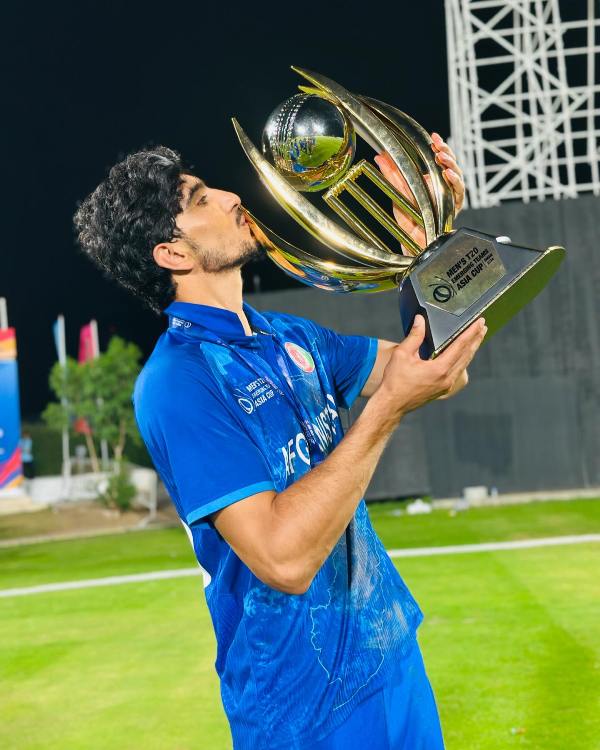 Sediqullah Atal kissing the ACC Emerging Teams Asia Cup trophy after winning the competition