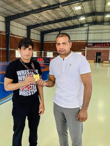 Seema Bisla with her coach, Paramjeet Yadav