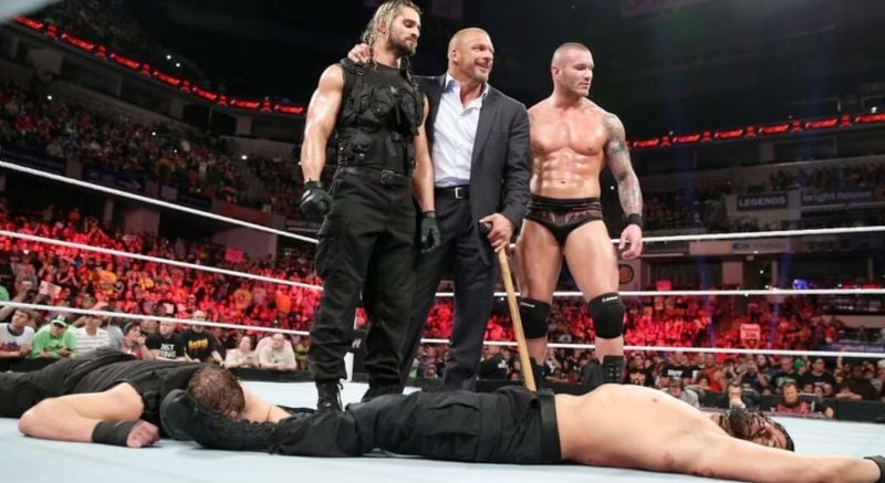 Seth Rollins with Triple H and Randy Orton after attacking the members of The Shield, Roman Reigns and Dean Ambrose