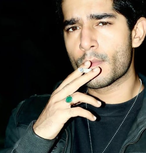 Shaan R Grover while smoking a cigarette