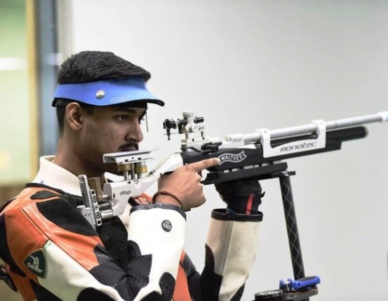 Shahu Mane with a rifle