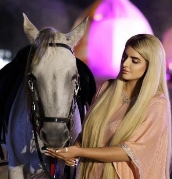 Sheikha Mahra posing with a horse