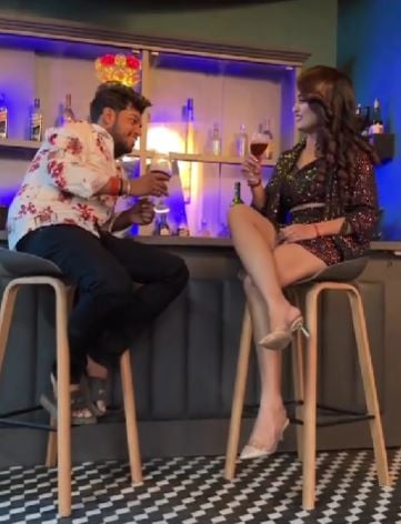 Shalinee Yadav holding a glass of wine