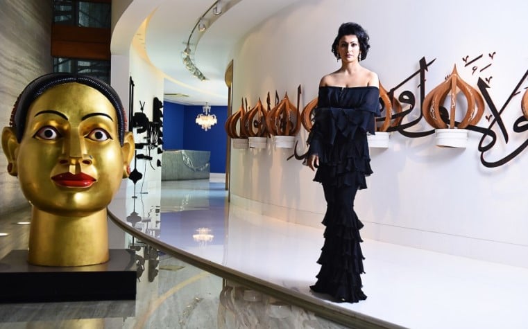 Shalini Passi posing with some of her art collections at her home