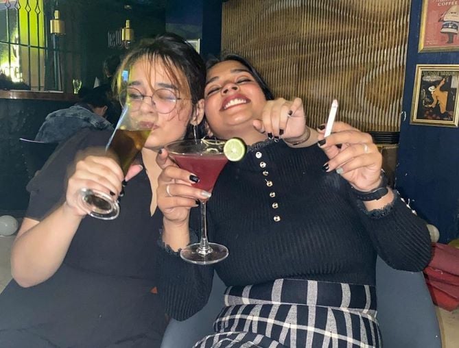 Shamita Yadav holding a cigarette and a glass of alcohol