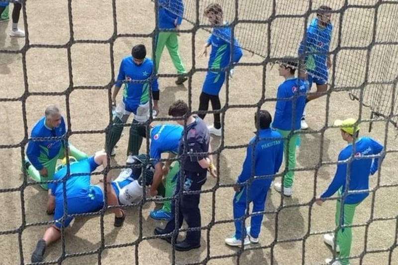 Shan Masood being attended by Pakistani players and coaches after he was hit on the head during practice