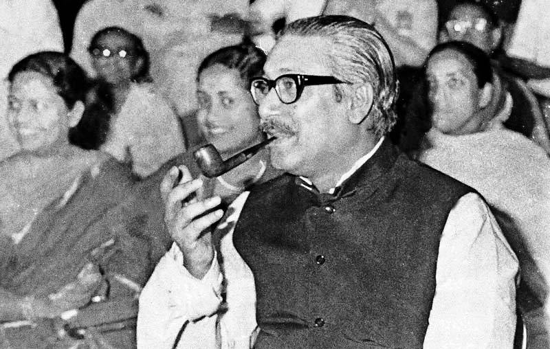 Sheikh Mujibur Rahman smoking a pipe