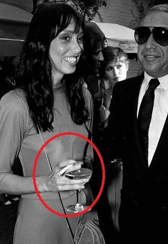 Shelley Duvall holding a glass of alcohol