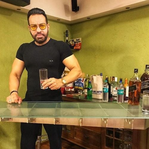 Shera holding a glass of alcohol