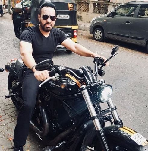 Shera sitting on his motorcycle