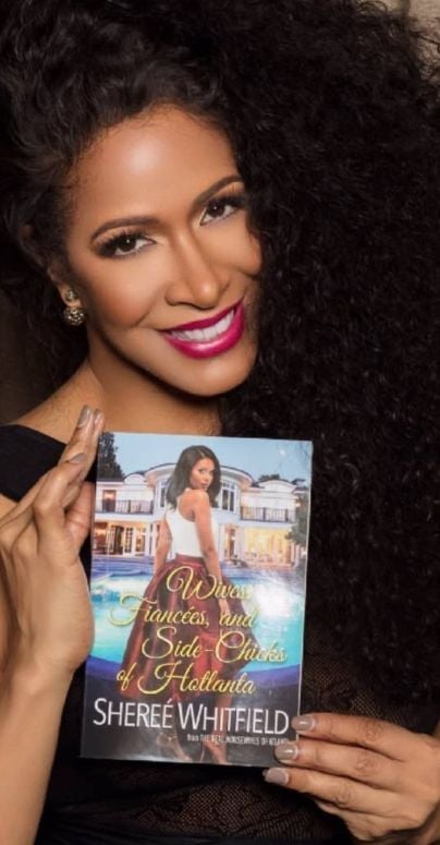 Shereé Whitfield with her book, Wives, Fiancees, and Side-Chicks of Hotlanta