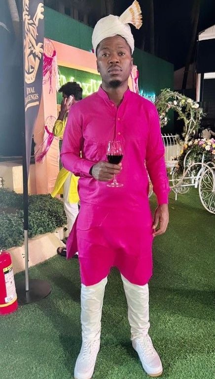 Sherfane Rutherford holding a glass of wine