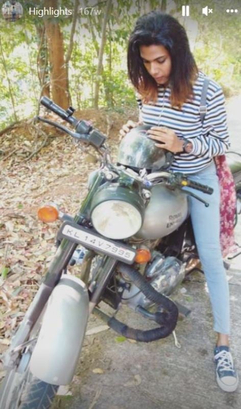 Sherin riding a Royal Enfield motercycle