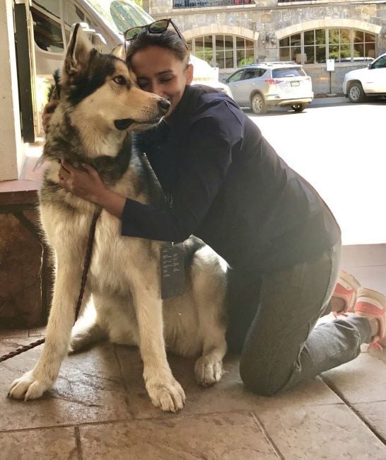 Shibani Gharat hugging a Siberian Husky dog