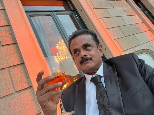 Shihan Hussaini with a glass of alcohol