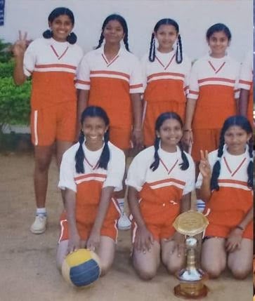 Shilpa Manjunath with her volleyball team in school