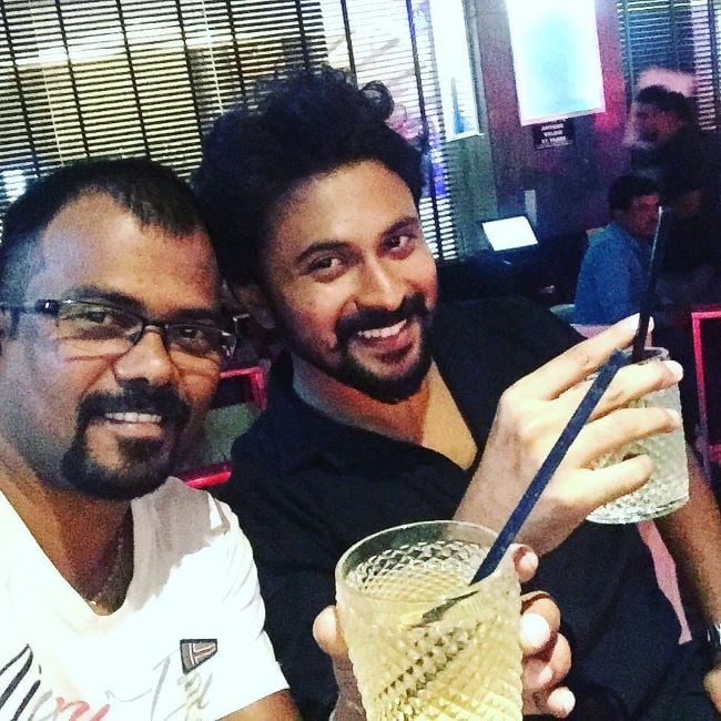 Shishir Shastry holding a glass of alcohol