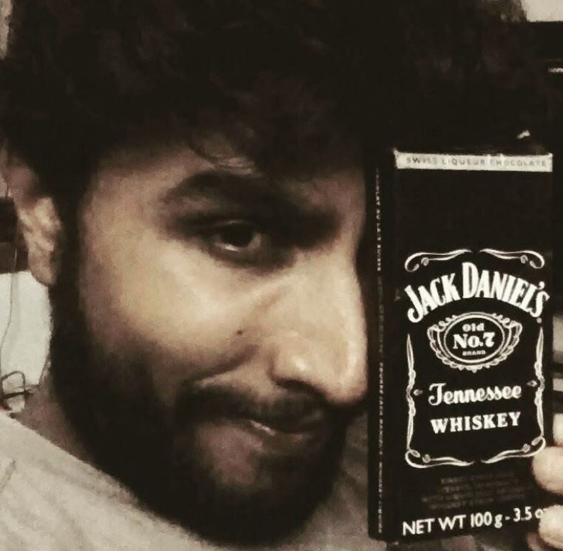 Shivaji Dev holding a liquor chocolate