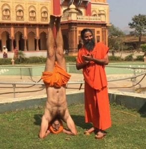 Shivendraa Om Saainiyol doing yoga in front of Baba Ramdev