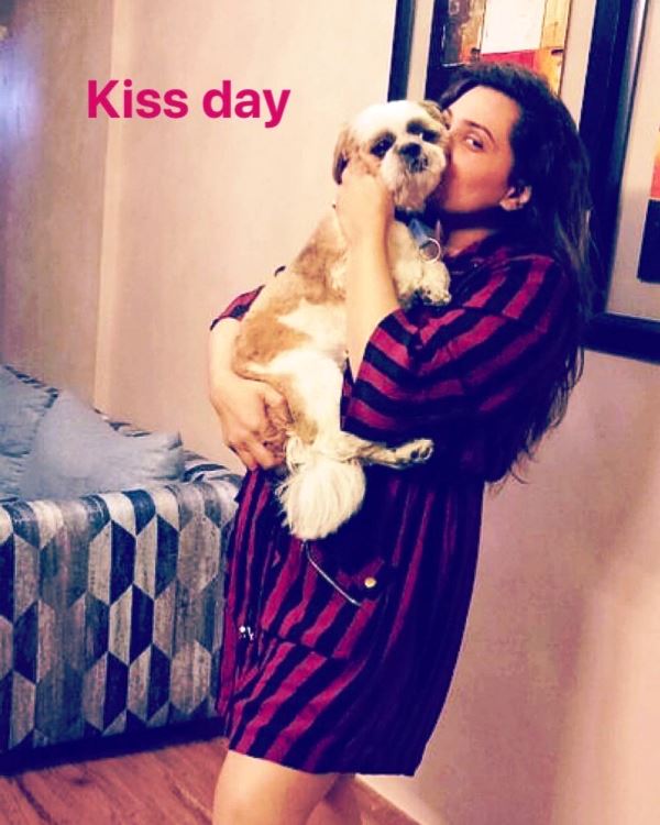 Shraddha Pandit posing for a photo with her pet dog Muffin