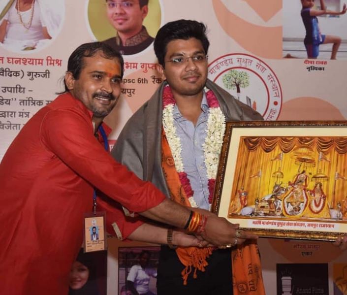 Shubham Gupta being awarded at an event by an NGO