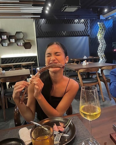 Shuvee Etrata with a glass of alcohol