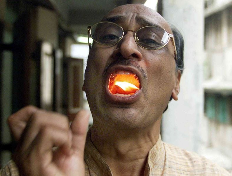 Shyam Manav with burning camphor in his mouth