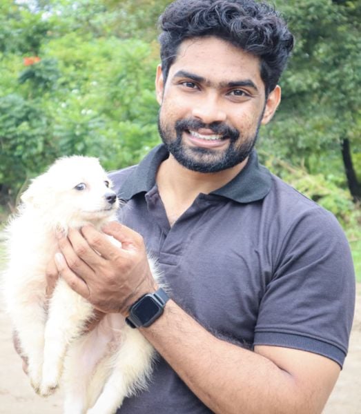 Sijo John playing with a dog