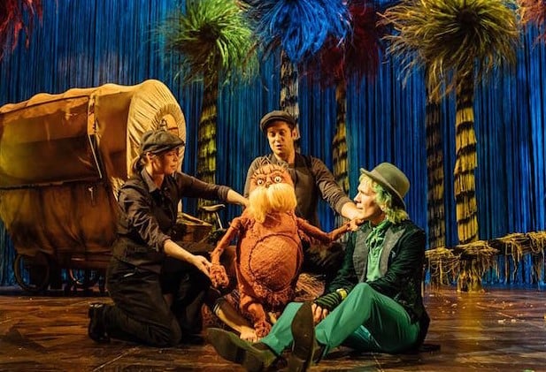Simon Paisley Day (in green suit) in a still from the theatre play The Lorax by David Greig (2017)