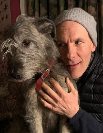 Simon Paisley Day posing with his pet