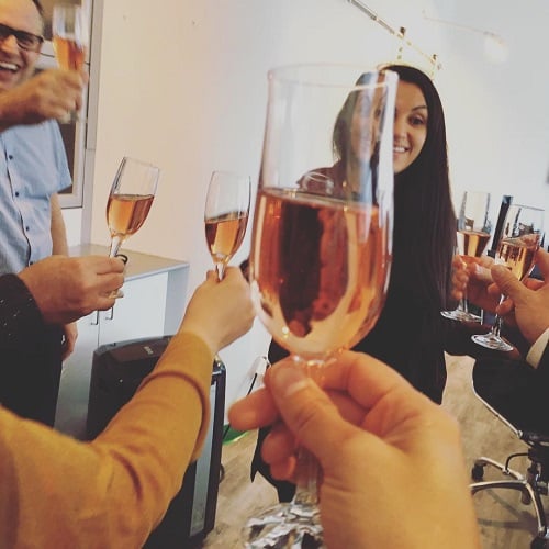 Sinem Kara holding a glass of alcohol