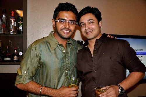 Sohail Kathuria holding a glass of alcohol