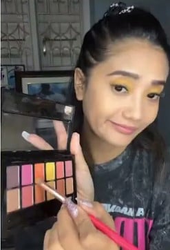 Soma Laishram while demonstrating a makeup tip on her YouTube channel