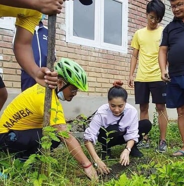 Soma Laishram while planting a sapling