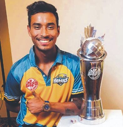 Sompal Kami posing with trophy after Winnipeg Hawks won