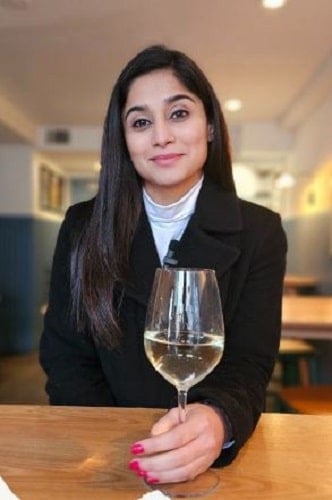 Somya Seth holding a glass of wine