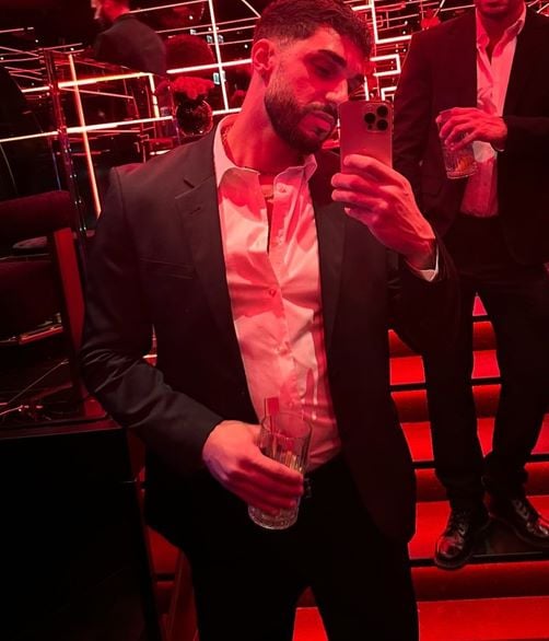 Stefano Tediosi holding a glass of alcohol