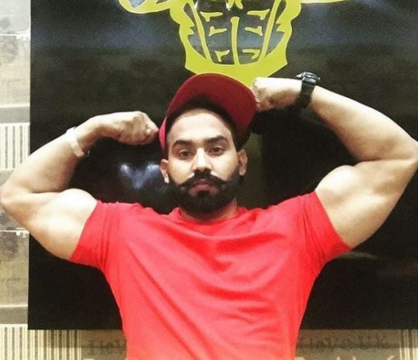 Sukh Sandhu showing his body at a gym