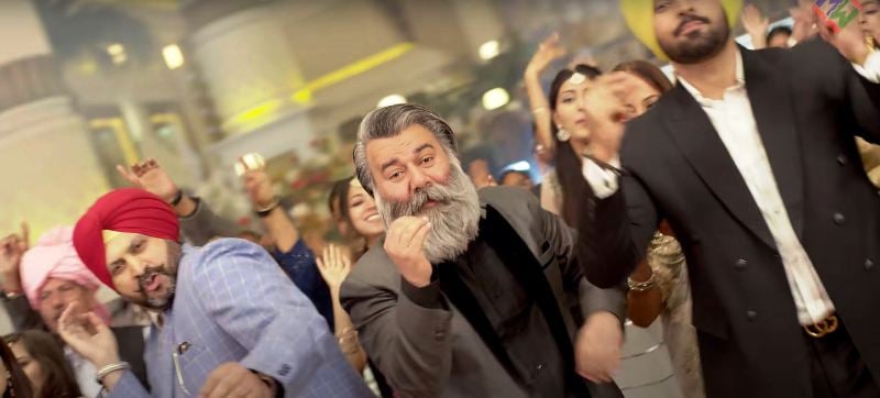 Sukhpal Singh (center) in the music video of Kali Ainak by Malkit Singh (2022)