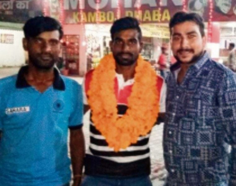 Sumit (centre) in front of the Mohan Kamboj Vaishno Dhaba