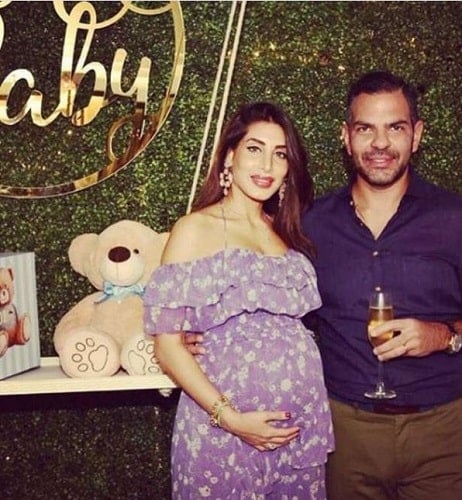 Sunjay Kapur at a party holding a glass of champagne