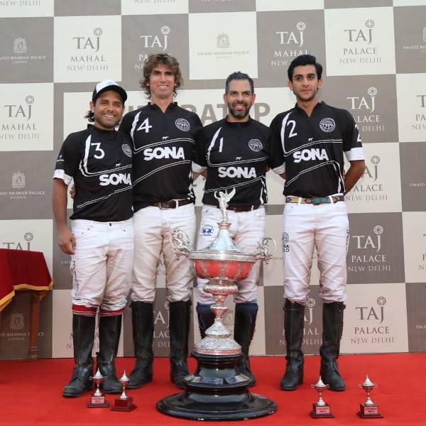 Sunjay Kapur with the team of Polo riders of his company posing with the trophy that they had won