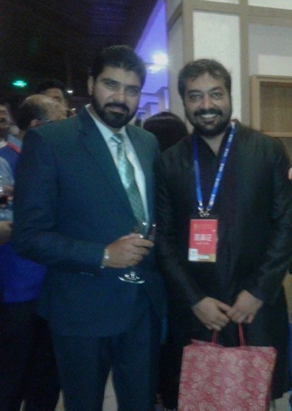 Suvinder Vicky (left) holding a glass of wine