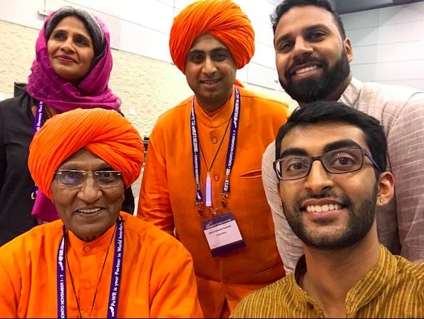 Swami Agnivesh, foreground left, with (clockwise) Sunita Viswanath, Swami Vedananda, Gautham Reddy and Nikhil Mandalaparthy of Sadhana, at the Parliament of World Religions, Toronto