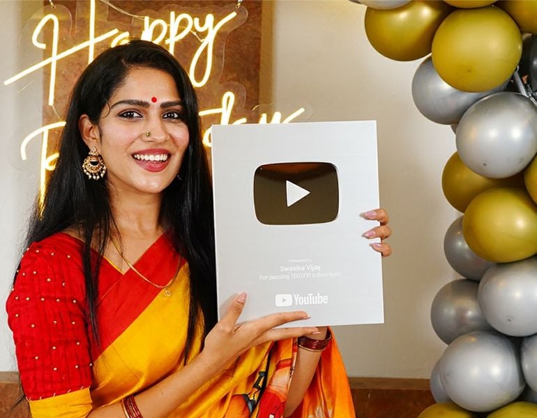 Swasika holding her Silver Play Button