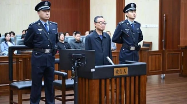 Tang Renjian (standing in middle) during a court proceeding