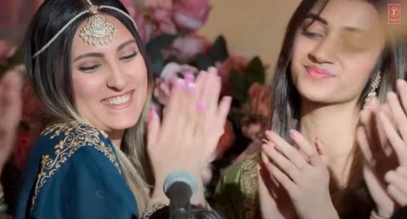 Tannaz Davoodi (left) in a still from the song 